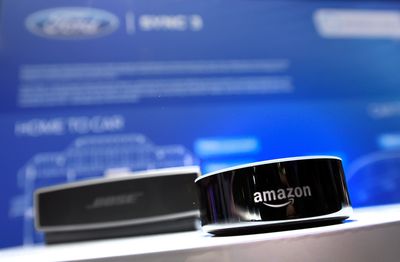 Dispositivo Amazon Echo exibido na frente de um alto-falante bluetooth Bose