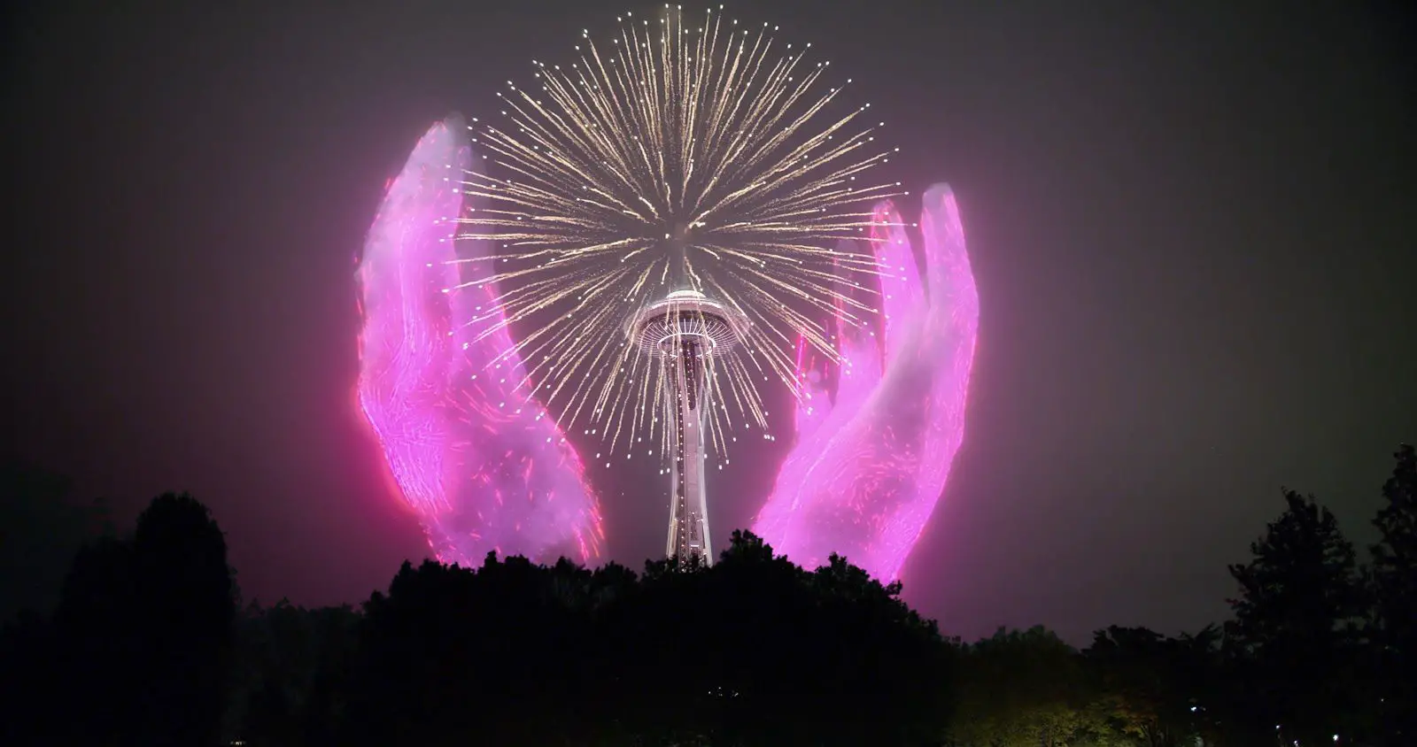 O Seattle Space Needle com fogos de artifício virtuais e mãos cor de rosa ao redor
