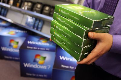 Homem carregando caixas de varejo de Windows 7